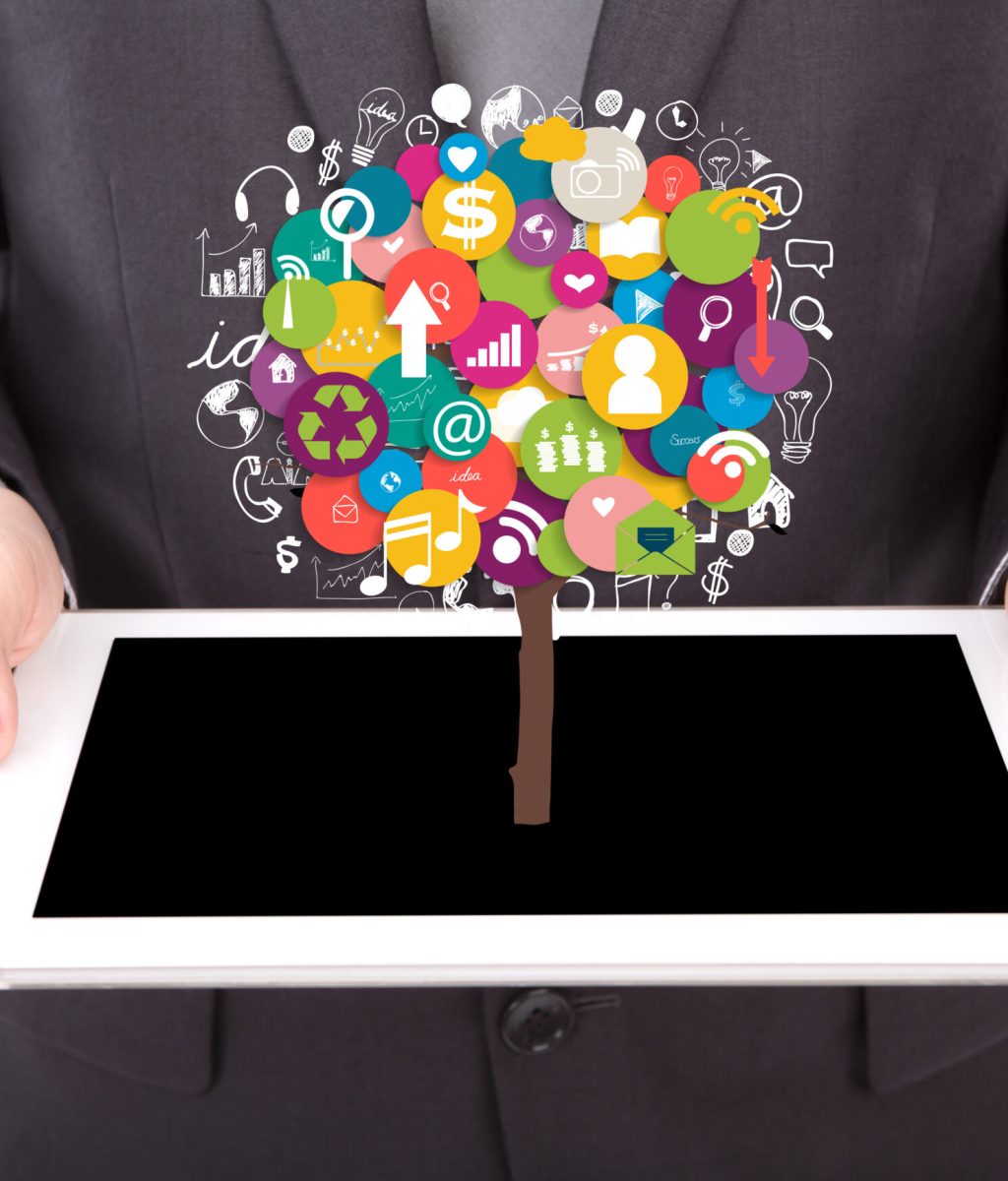 Portrait of young business man using a touch screen device with tree of application